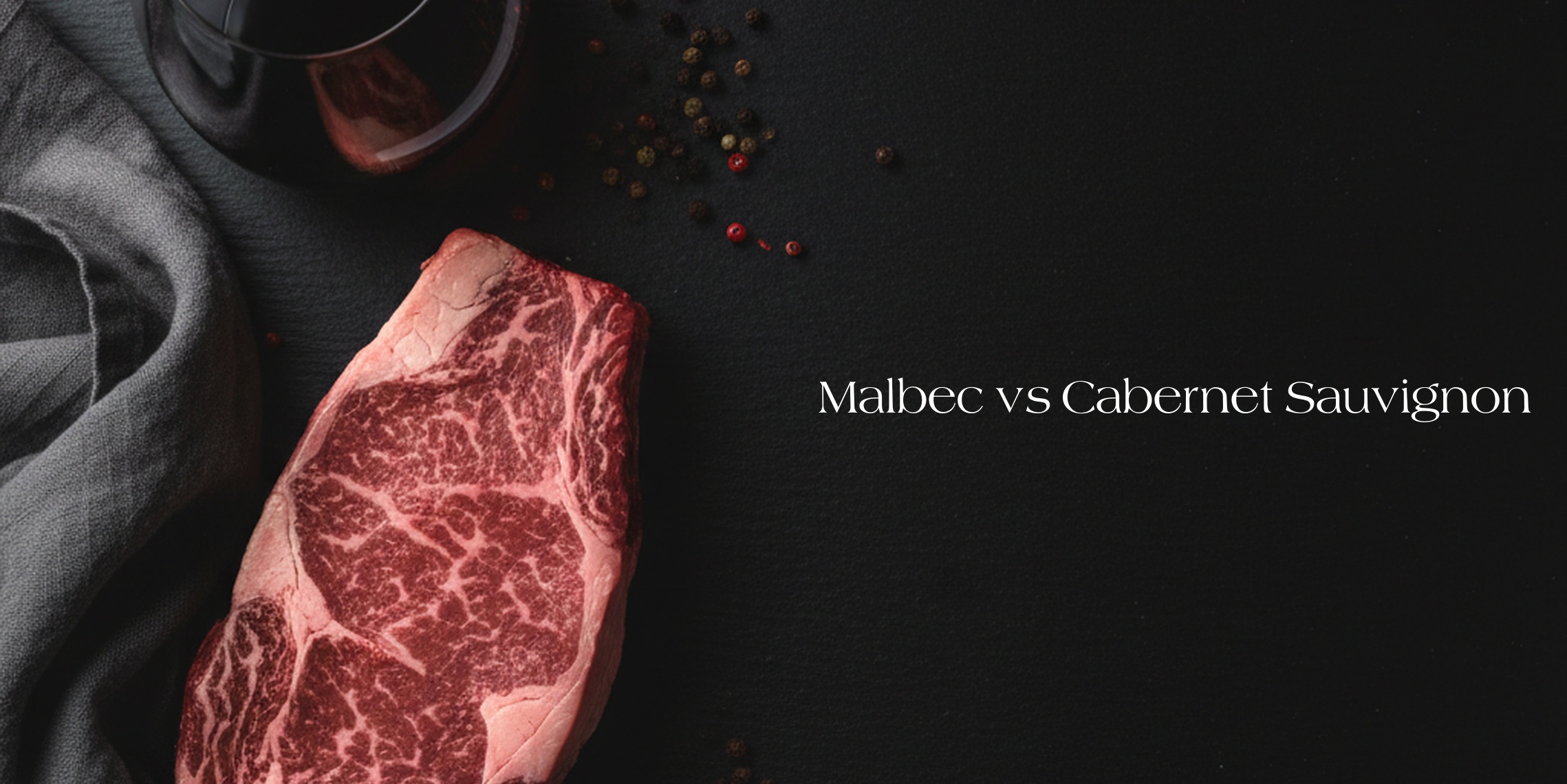 Raw marbled steak and a glass of red wine beside the words ‘Malbec vs Cabernet Sauvignon.’